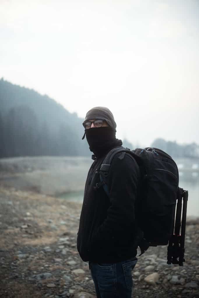 Man in Black Jacket with a Bulky Backpack